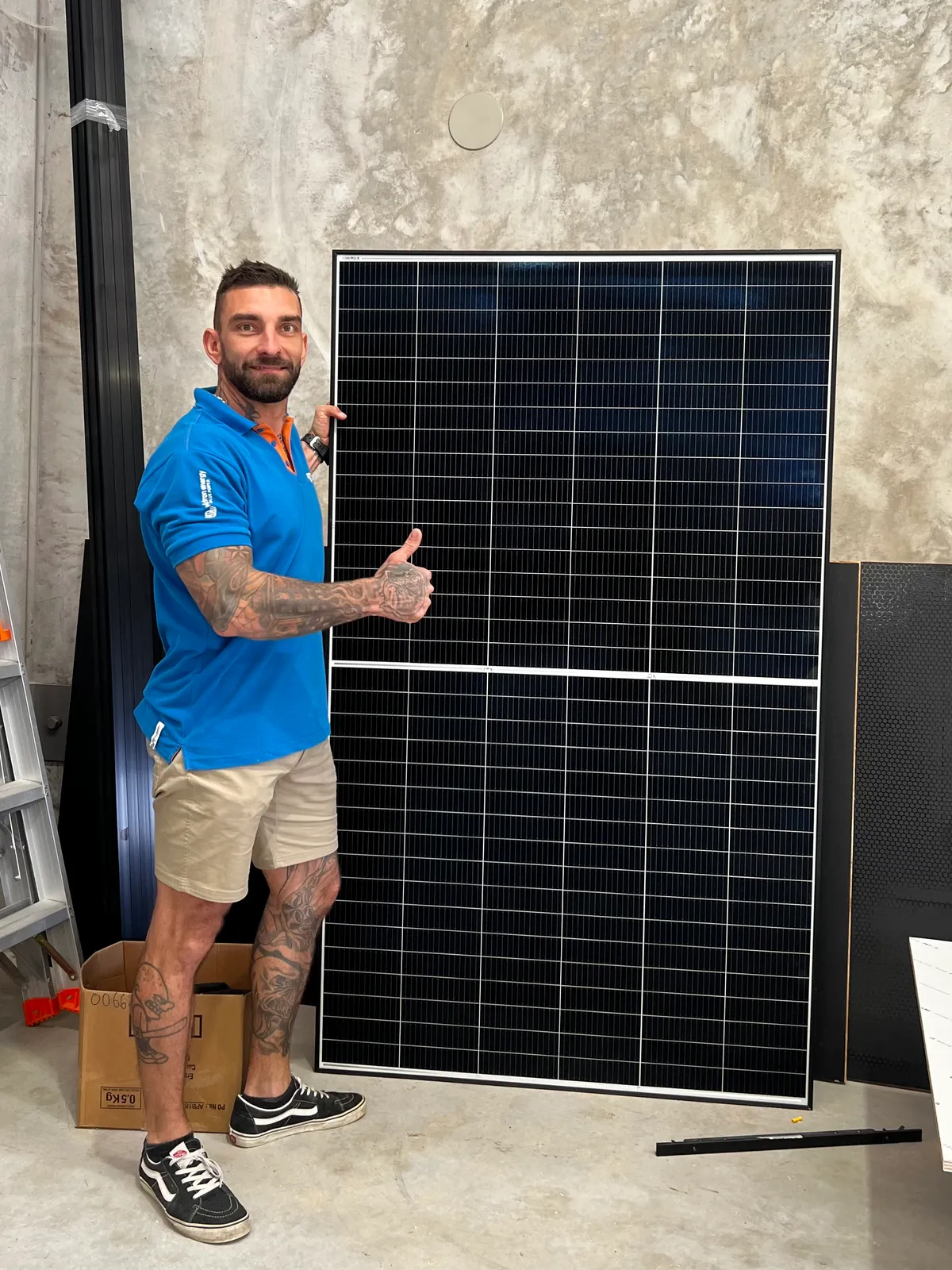 Jon, owner and off-grid power specialist, with a solar panel in the OffXgrid workshop