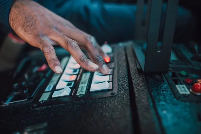 Hand pressing a backlit rocker switch panel