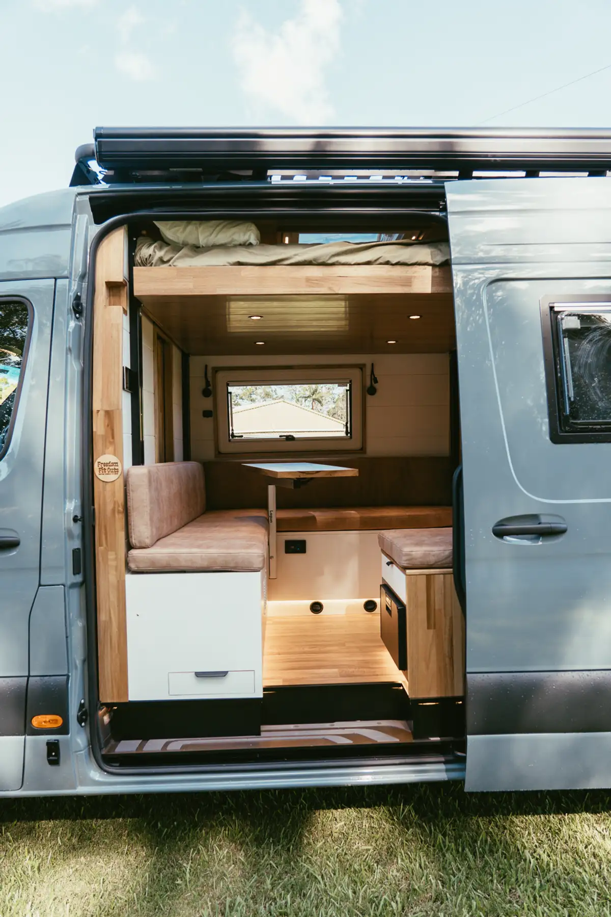 Sprinter van with the side door open showing the finished fit-out