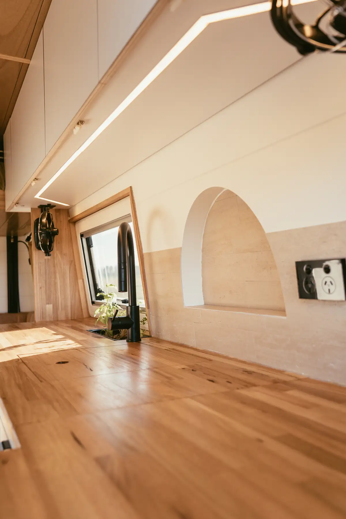 Ceiling LED strip running the length of the van, with a 240V outlet on the wall